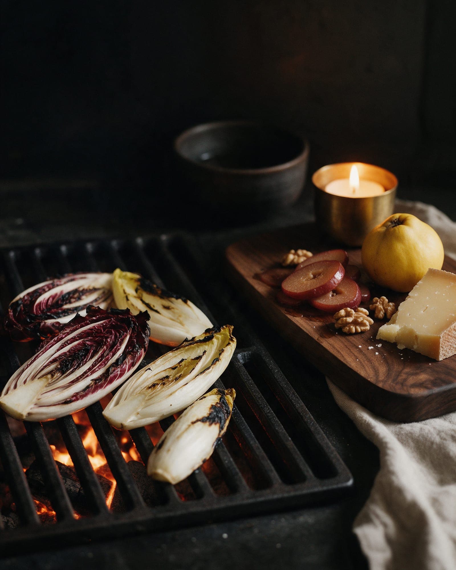 Radicchio and endive charring on the grate, poached quince, walnuts and comte waiting on a walnut board.