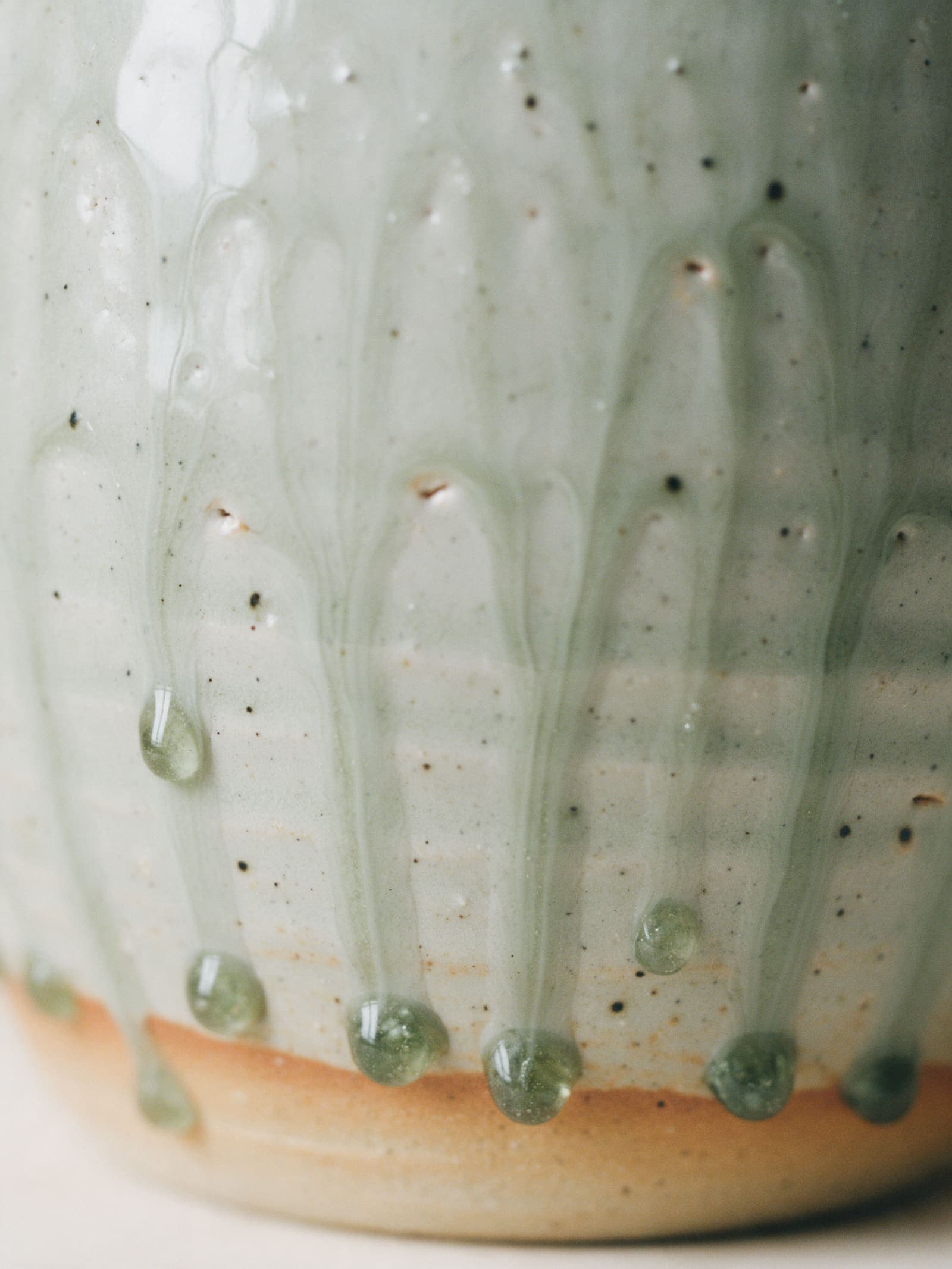 Ash glaze running in drips over the throwing rings