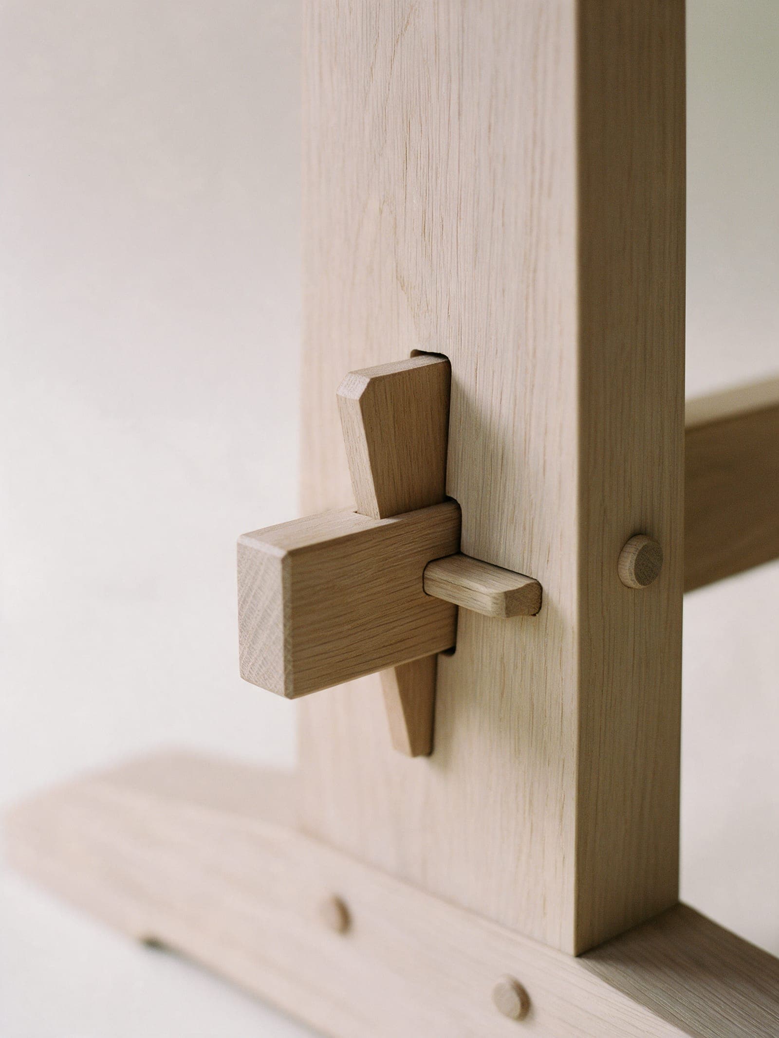 Pale soaped white oak at the wedged joint of the trestle table