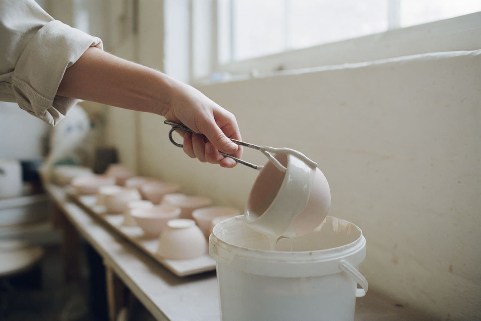 A bisque bowl dipped into pale ash glaze