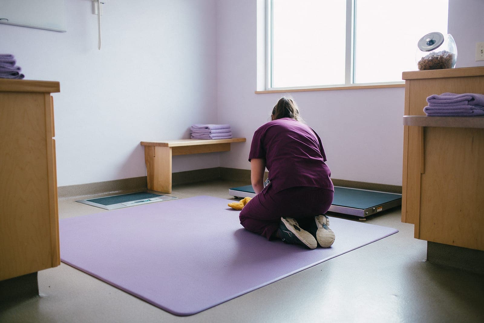 A dog room with a non-slip mat on the floor and a scale flush with the floor.