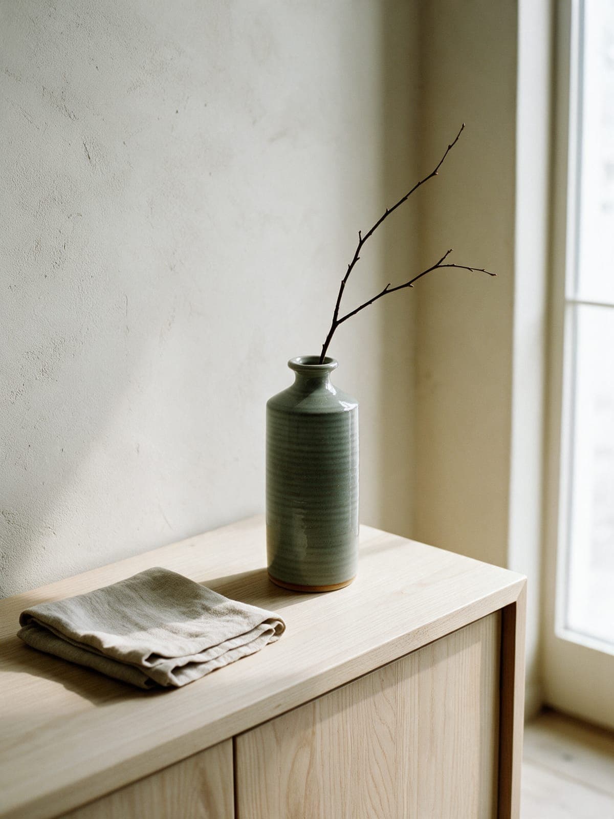 Vessel No. 4 holding one bare branch on a white oak sideboard