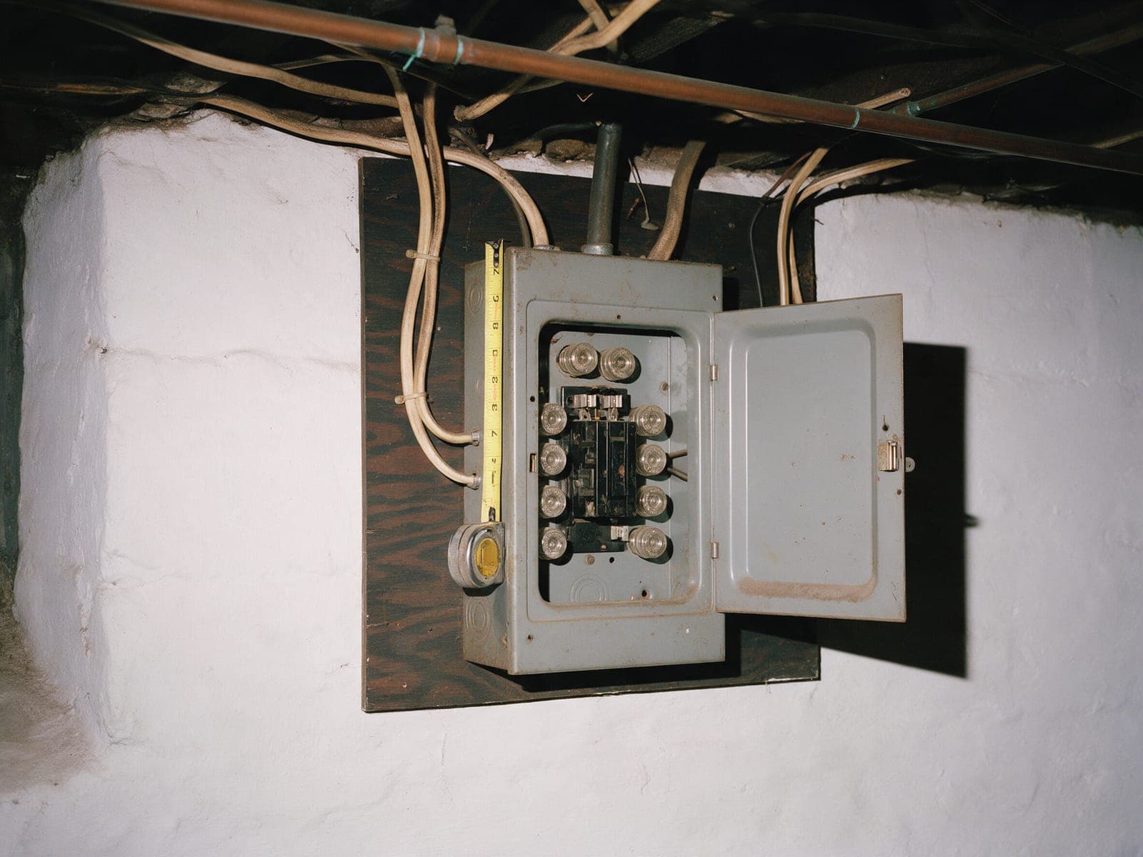 Existing 100 A fuse box in a Queens basement, photographed during a site visit.