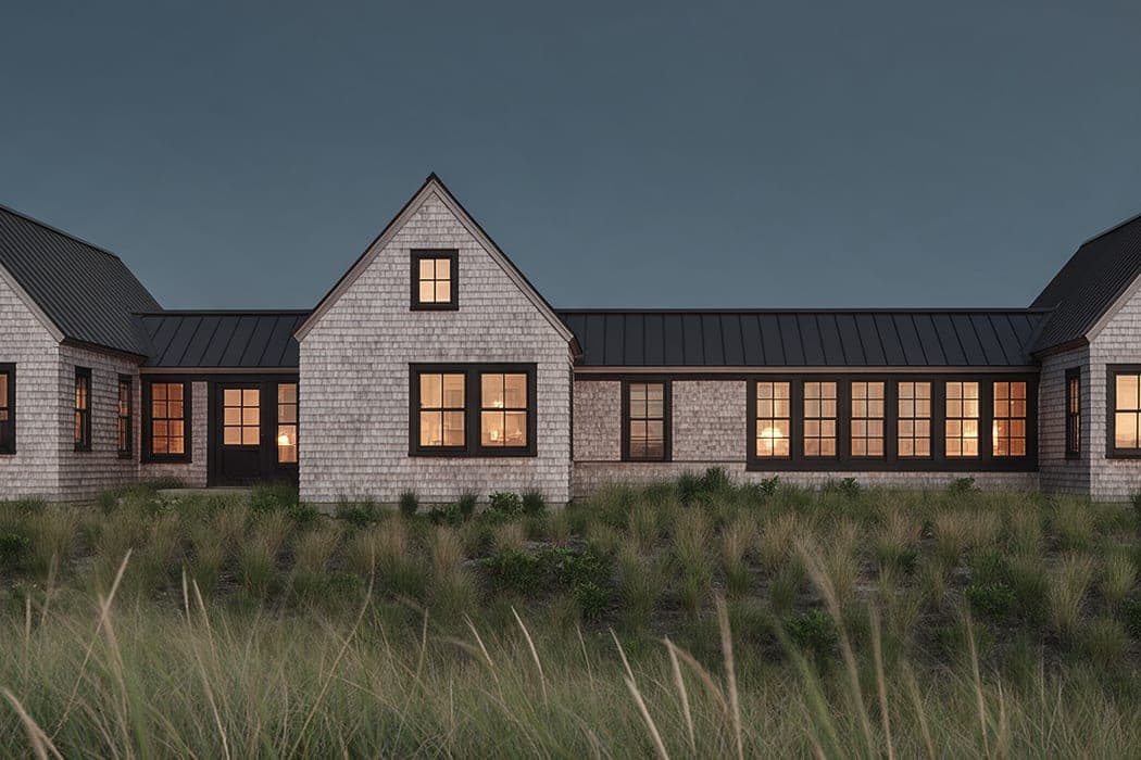 The middle gable of Dune Shingle House, its white cedar shingle weathered to silver above the meadow grass.