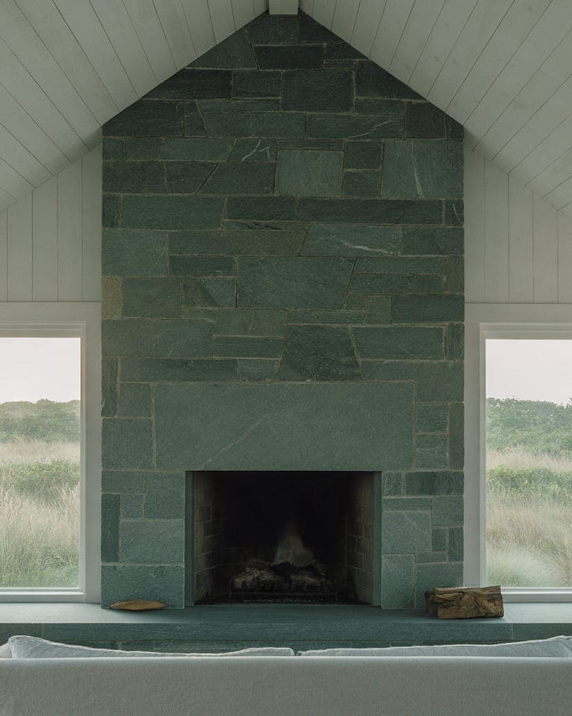 The bluestone hearth under the middle gable of Dune Shingle House.