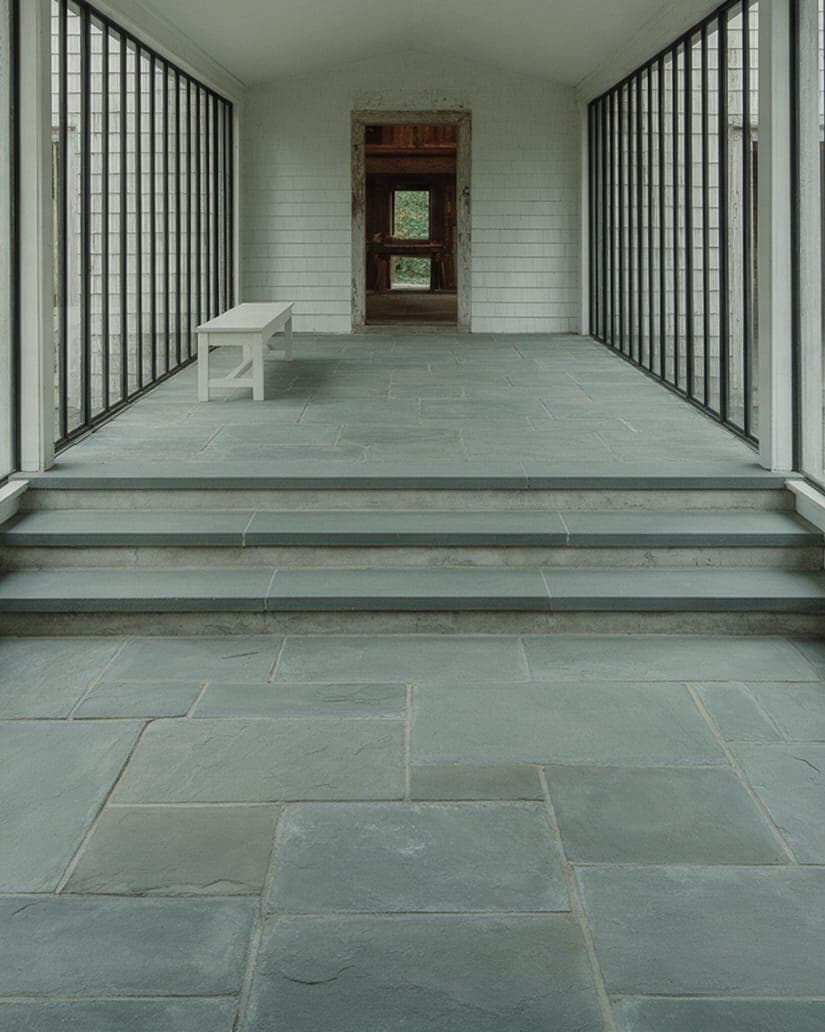 Bluestone steps in the glass hall at Gable Pair, where the two old floor levels meet.
