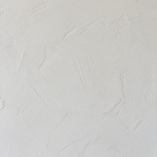Lime plaster with a soft trowel texture.