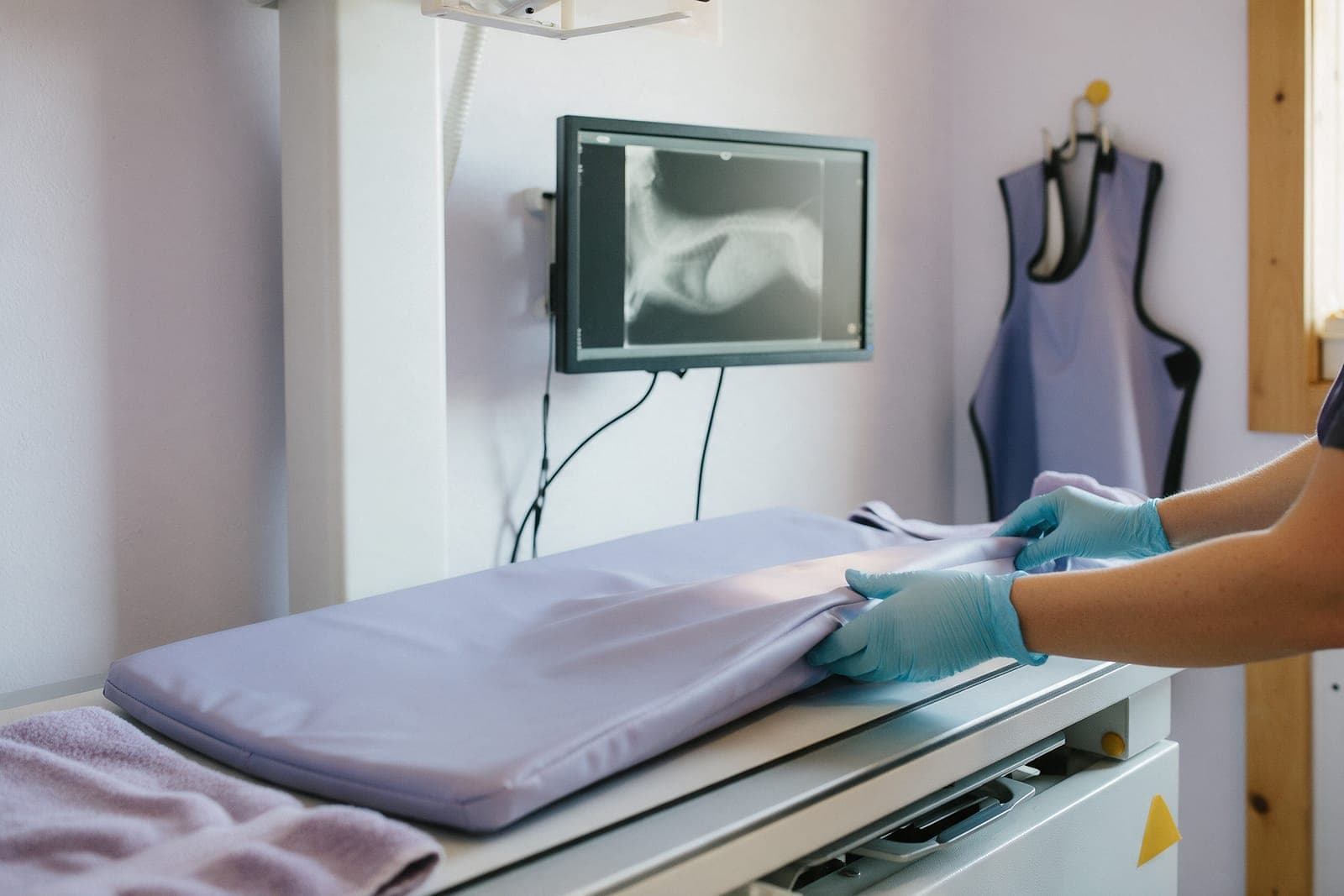 The imaging room, with a padded table and the screen where x-rays come up.