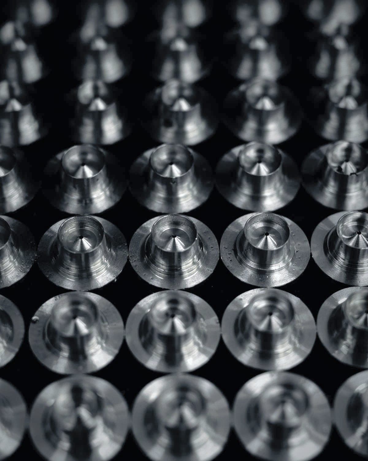 Rows of turned spacers standing on the kitting tray