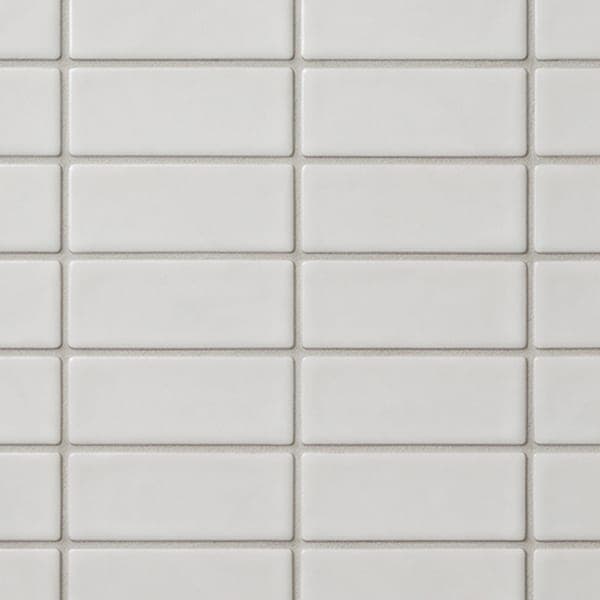 Small glazed white wall tiles with thin grey grout.